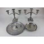 A pair of silver plated candelabra with three sconces and embossed vine leaf design, together with