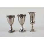 A near pair of Israeli white metal Kiddush cups with gilt interiors and wire design, one with