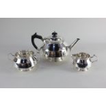 An Arts and Crafts style silver plated three-piece tea set of teapot, sugar bowl and milk jug,