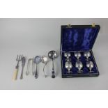 A cased set of six silver plated liqueur goblets, together with a silver plated sauce ladle,