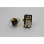 A smoky quartz dress ring in 9ct gold, and a tiger's eye ring in 9ct gold