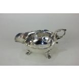 A George II silver sauce boat, maker IW, London, 1755, with scalloped border on hoof feet (a/f)