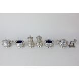 An Indian white metal cruet set marked sterling silver, comprising pair of peppers, pair of salts,