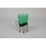 A Russian 84 Zolotniks white metal tea glass holder with green glass