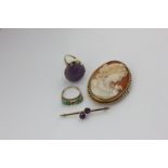 A carved amethyst dress ring in 9ct gold, a turquoise ring (a/f), a shell cameo brooch, and an