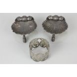 A pair of Victorian silver salts, scallop shell form, on three dolphin feet, maker Alexander Macrae,