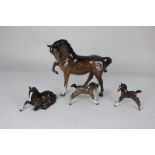 A Beswick chestnut glazed model of a horse with front leg raised, 22cm, another smaller model of a