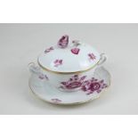 A Herend porcelain two-handled chocolate cup and saucer in pink Chinese rose pattern (a/f)