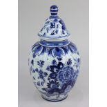 A 20th century Delft porcelain jar and cover with blue and white floral design, 25cm high