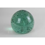 A large Victorian globular green glass dump weight with central teardrop amongst bubbles, rough