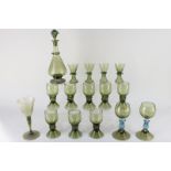 A collection of green glass in the style of James Powell & Sons Whitefriars, comprising a decanter