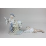 A Nao porcelain model of a cat, together with a Spanish porcelain model of a boy with a donkey, 25cm