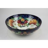 A large Moorcroft pottery 'Anna Lily' bowl decorated with orange flowers on blue and cream ground,