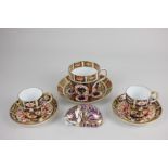 A Royal Crown Derby porcelain teacup and saucer in the Imari pattern 1128, together with a pair of