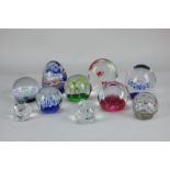 Ten various glass paperweights including Caithness Celebration and Millennium Carousel