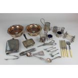 A pair of silver plated bottle coasters, a hip flask, cruet sets, knife rests, grape scissors and