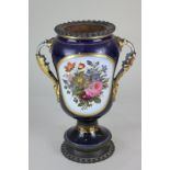 A porcelain and gilt metal mounted two-handled vase decorated with panels of flowers, on dark blue