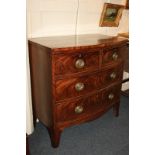 A 19th century bow front mahogany chest of three graduated drawers with oval brass drop handles,