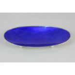 A Danish silver and blue enamel oval dish by E Dragsted, on ball feet, marked sterling Denmark E.