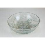 A Lalique 'chiens' glass bowl with green accents, decorated with dogs, raised mark R Lalique, 24cm