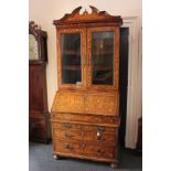 An 18th century Dutch walnut and marquetry bureau bookcase, the bureau with fall front enclosing