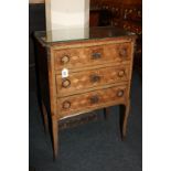 A French parquetry and gilt metal mounted small chest of three drawers, with diamond inlaid