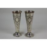 A pair of Victorian silver bud vases, makers Josiah Williams & Co, London 1897, with embossed floral