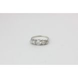 A diamond five-stone ring claw set with graduated old cuts in platinum