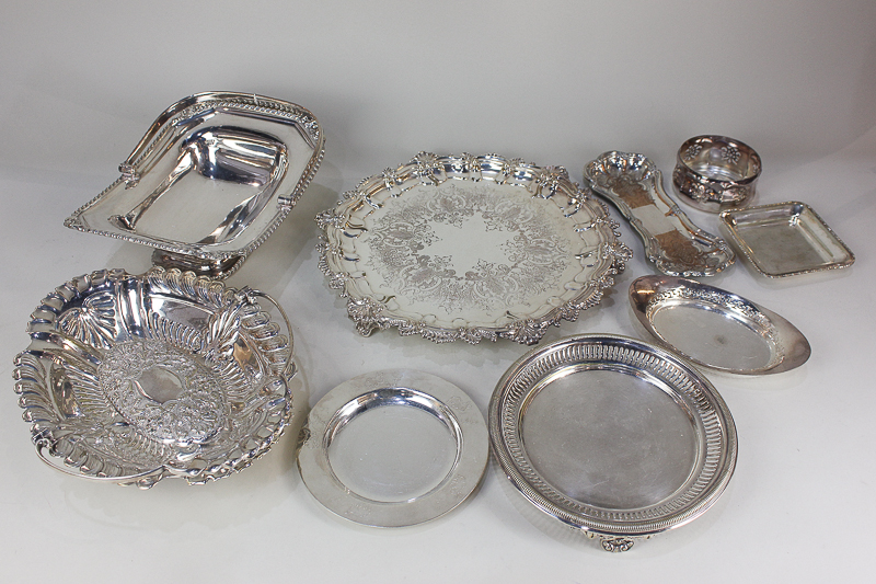 A collection of silver plated wares including two cake baskets, salvers, trays and dishes