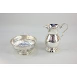 A Victorian silver cream jug, maker Florence Warden, Chester 1897, and a Dobson & Sons silver
