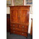 A 19th century mahogany linen press, the two panel doors enclosing three shelves above a chest of