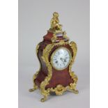 A 19th century French tortoiseshell and gilt metal mounted mantel clock, the shaped case decorated