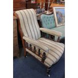 A Victorian mahogany armchair with striped upholstery, the padded arms on balustrade supports, on