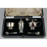 A George V silver cased cruet set, makers Adie Brothers Ltd, Birmingham 1930, with two matching