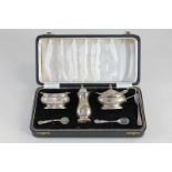 An Elizabeth II silver cased cruet set, makers William Suckling Ltd, Birmingham 1957, with two