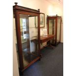 A pair of late Victorian mahogany display cabinets with three-quarter pierced gallery top and urn