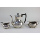 A George V silver three-piece coffee set, makers Walker & Hall, Sheffield 1924, of half reeded form,