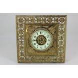 A late 19th century brass framed timepiece with square shaped frame decorated with scallop shells