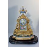 A Louis XVI style porcelain and gilt metal mantel clock with urn surmount, the Sevres style dial
