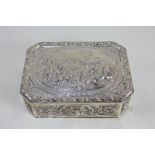 A German 800 silver embossed rectangular box with canted corners, depicting bacchanalian putti,