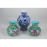 A Chinese blue and white porcelain moon flask decorated with birds amongst flowers and foliage,