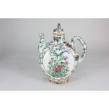 A Chinese porcelain teapot of flattened globular form, decorated with birds amongst flowering