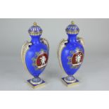 A pair of 19th century Coalport porcelain vases and covers, of oval form with scroll handles, on