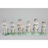 Six Derby porcelain putti figures, all carrying baskets of flowers, with patch marks to base,