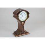 An Art Nouveau mahogany inlaid mantel clock, the waisted case decorated in satinwood and mother of