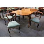 A set of six Victorian carved mahogany balloon back dining chairs with green upholstered seats, on