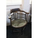 A 19th century mahogany stained corner elbow chair with carved design and green oval seat