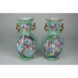 A pair of Chinese porcelain famille verte two-handled vases of flattened ovoid form with fluted