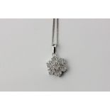 A diamond cluster pendant in 18ct white gold