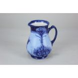 A William Moorcroft MacIntyre & Co Florian Ware jug decorated in shades of blue with sinuous